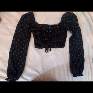 Forever 21 size small color I’d black with red roses